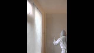 Spraying interior walls with an airless sprayer [upl. by Adelaida]