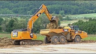 Excavator Cat 330F and dumpers Cat 730C2 work on highway [upl. by Eihtur939]